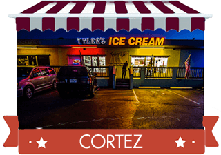 red striped awning over photo of shop at night with red banner reading Cortez Location